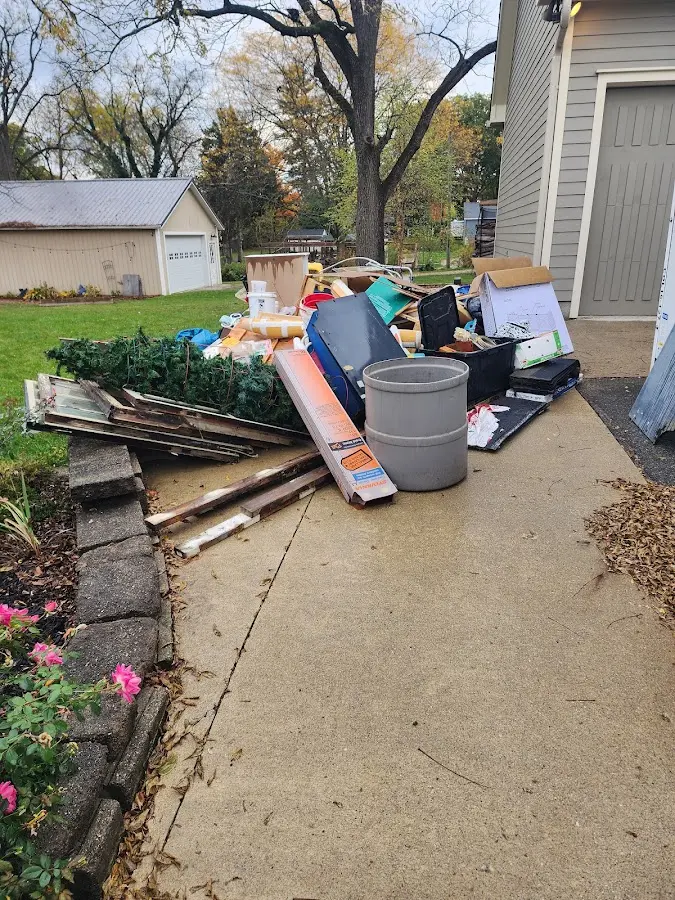 Dumpster being loaded with debris for Commercial Dumpster Rental in East Providence